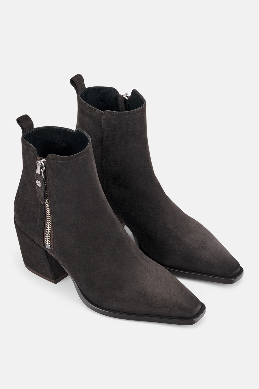 Pair of brown ankle boots with zippers on a white background