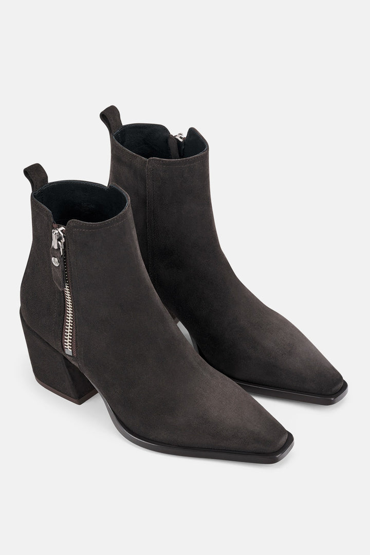 Pair of brown ankle boots with zippers on a white background