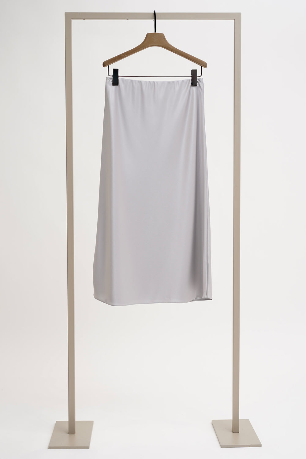 White skirt on a hanger against a white background