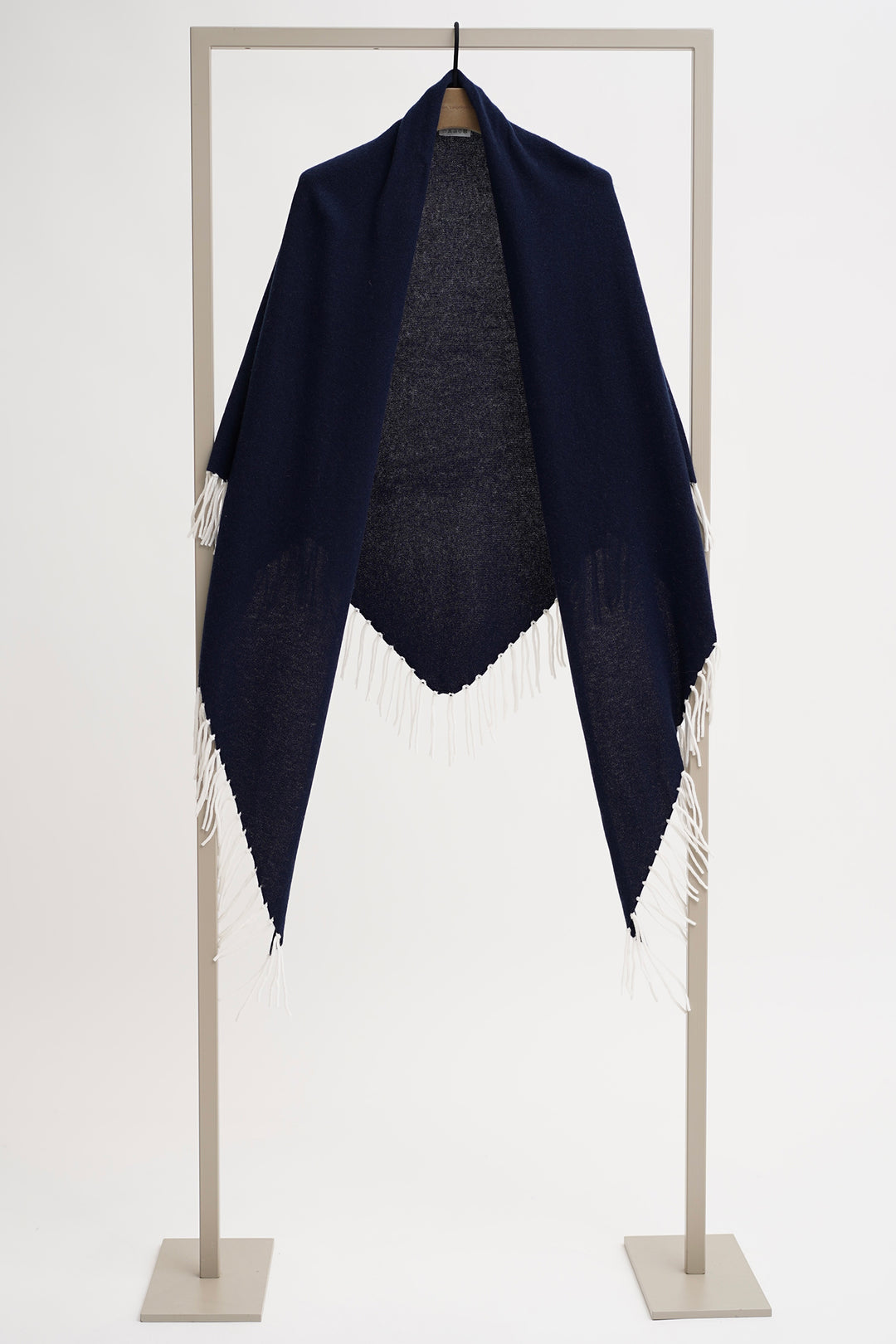 Navy blue shawl with white fringe on a white background