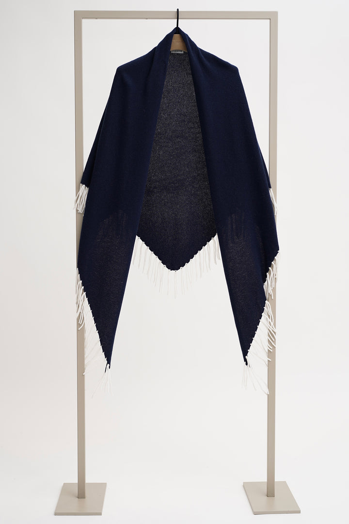 Navy blue shawl with white fringe on a white background