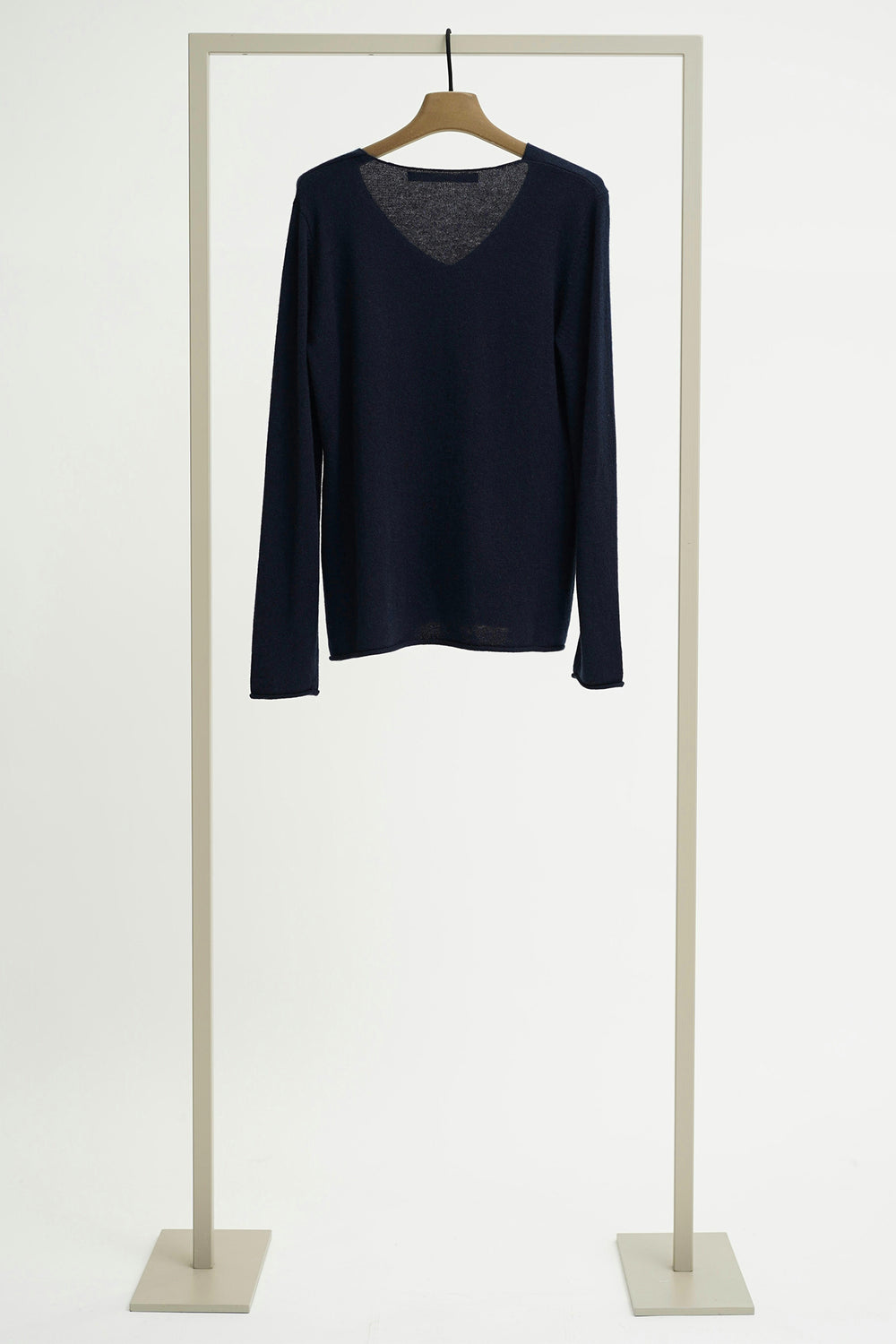 Navy long-sleeve shirt on a hanger against a white background