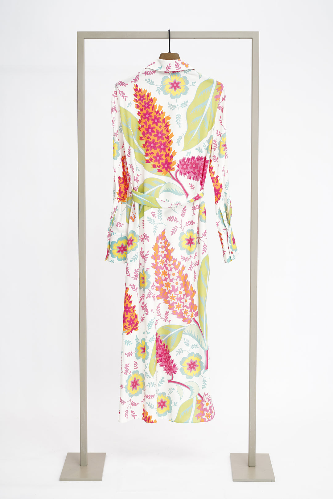 Colorful floral dress on a clothes hanger against a white background to show back of dress