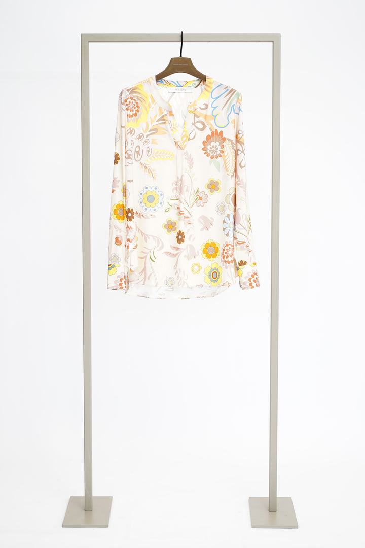 Floral blouse to show front on a hanger with a white background