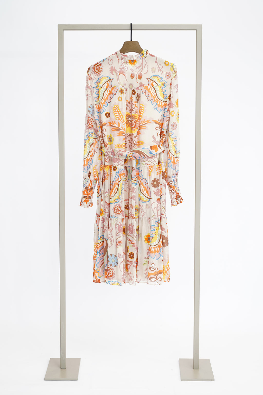 Floral dress on a hanger against a white background to show rear of dress