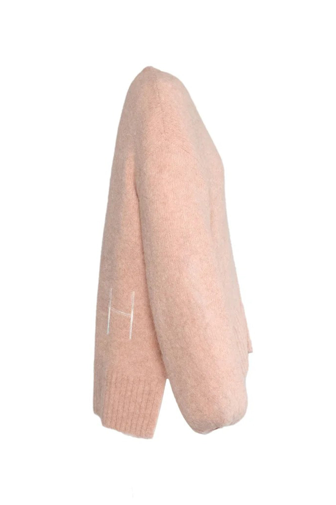 Light pink knitted sweater on a white background