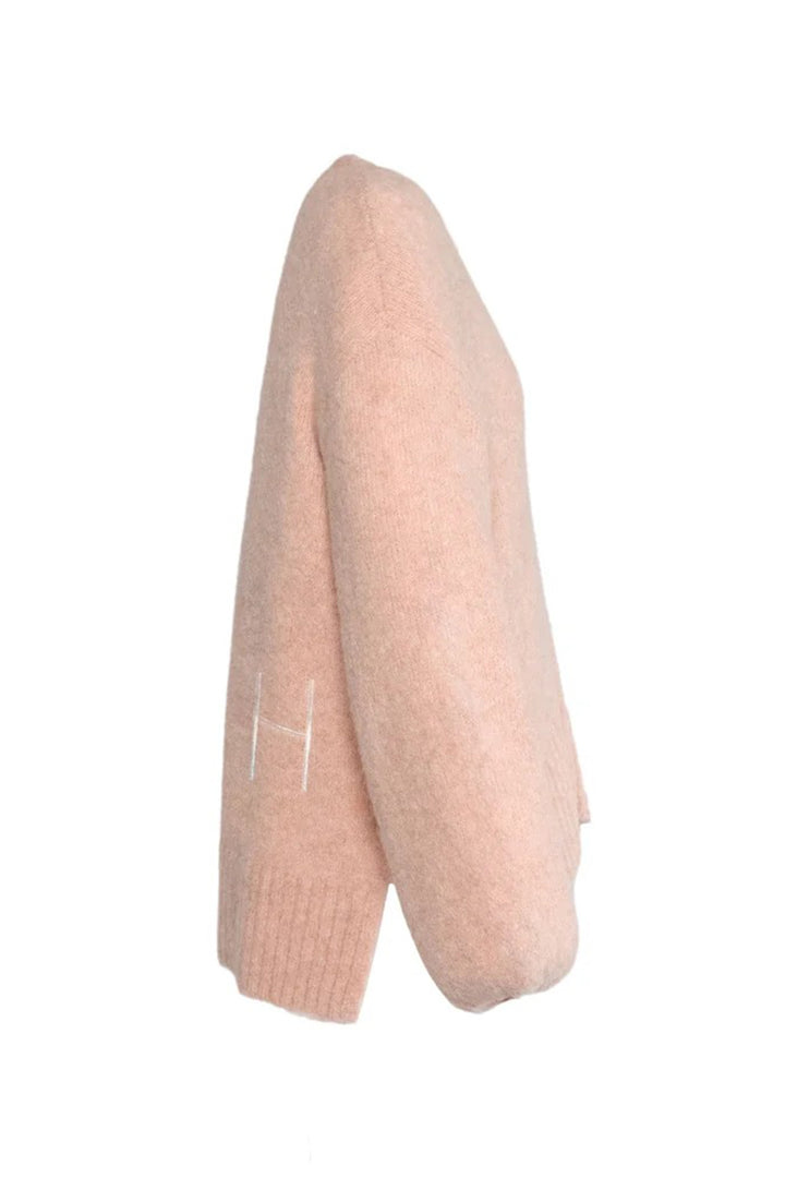 Light pink knitted sweater on a white background