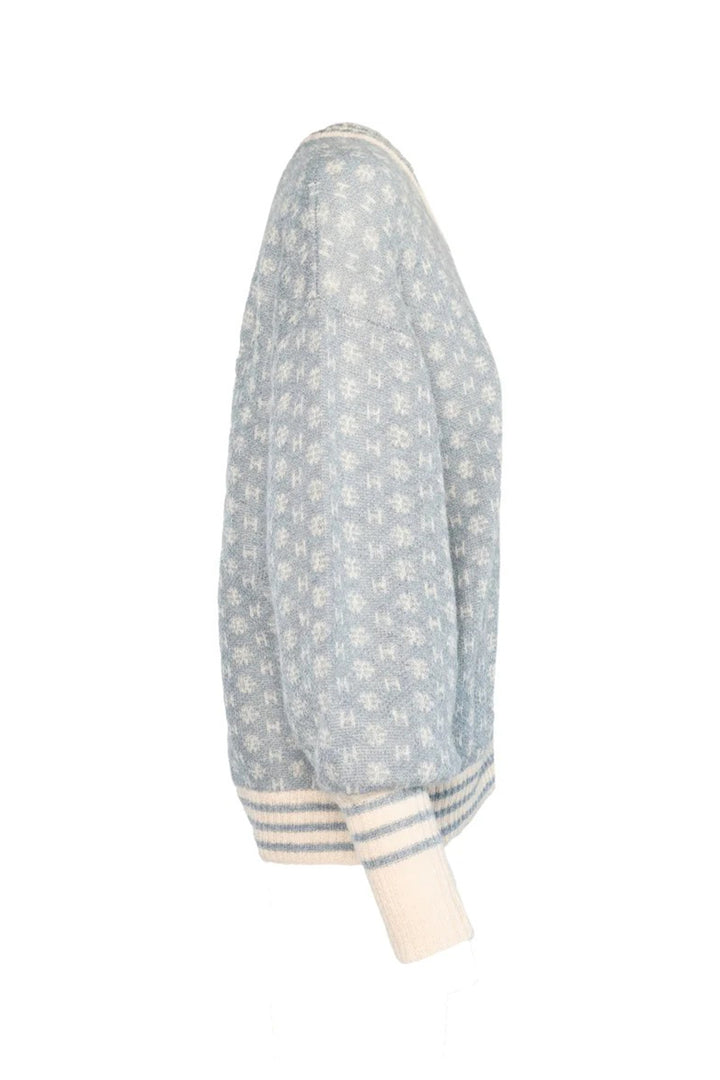 Light blue patterned sweater with white cuffs on a white background