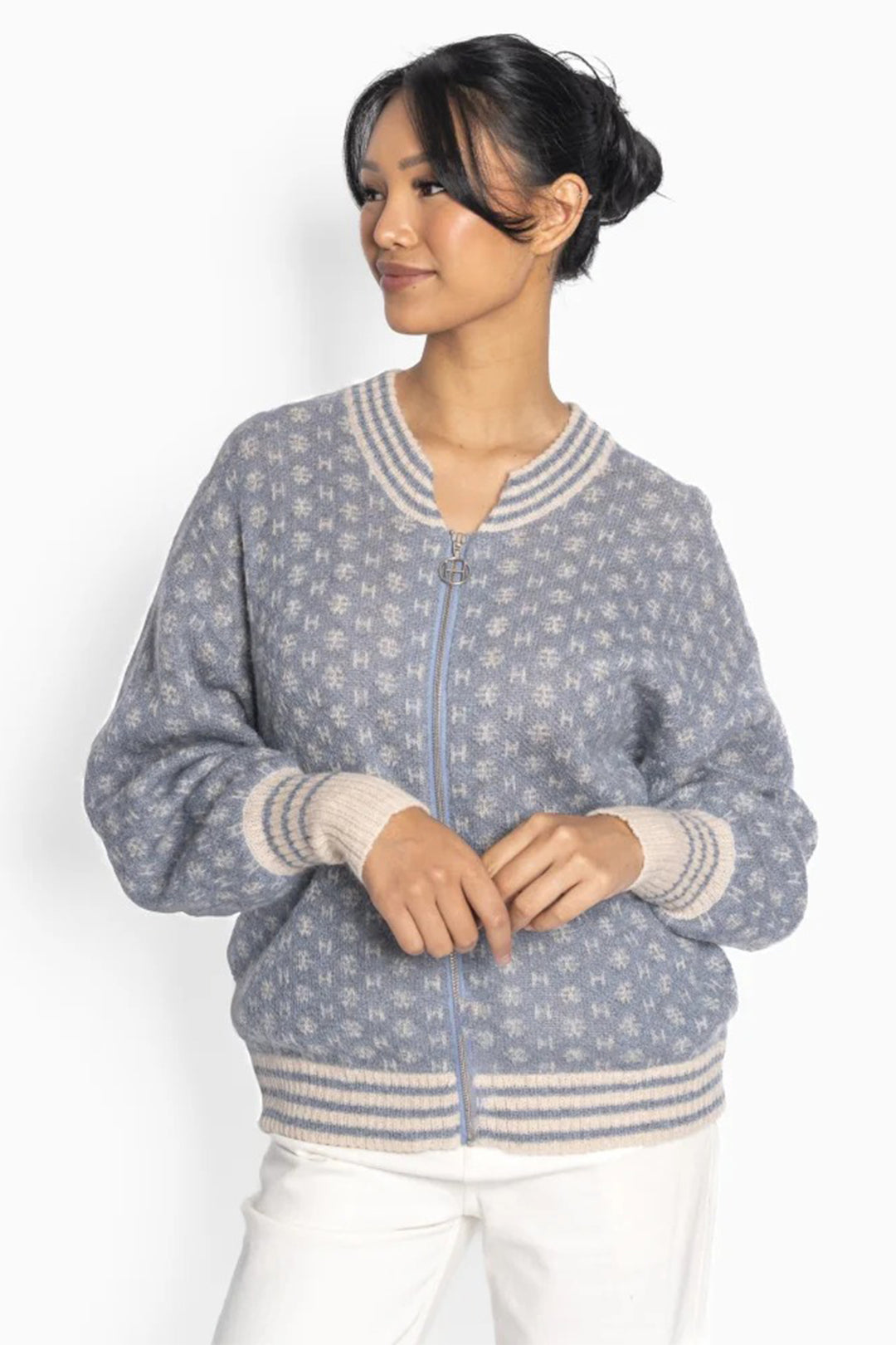 Woman wearing a patterned sweater on a white background