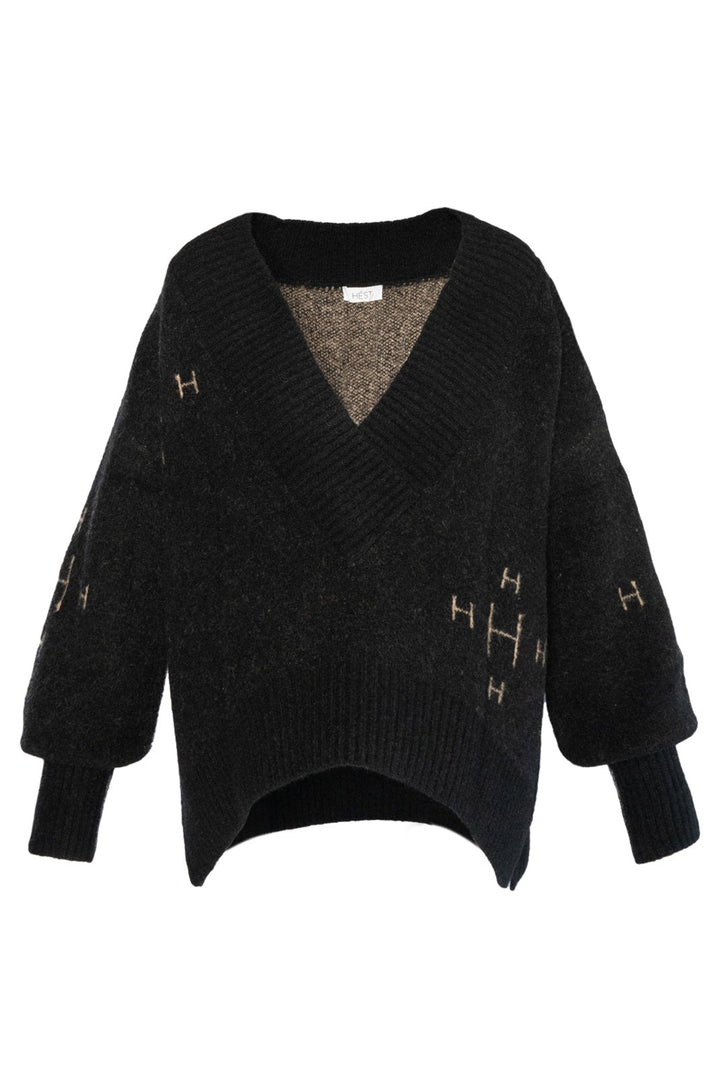 Black sweater with gold letter 'H' details on a white background