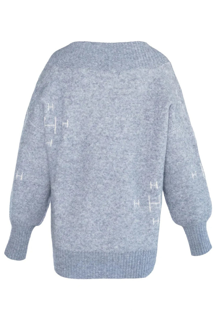Light blue sweater with subtle pattern on a white background