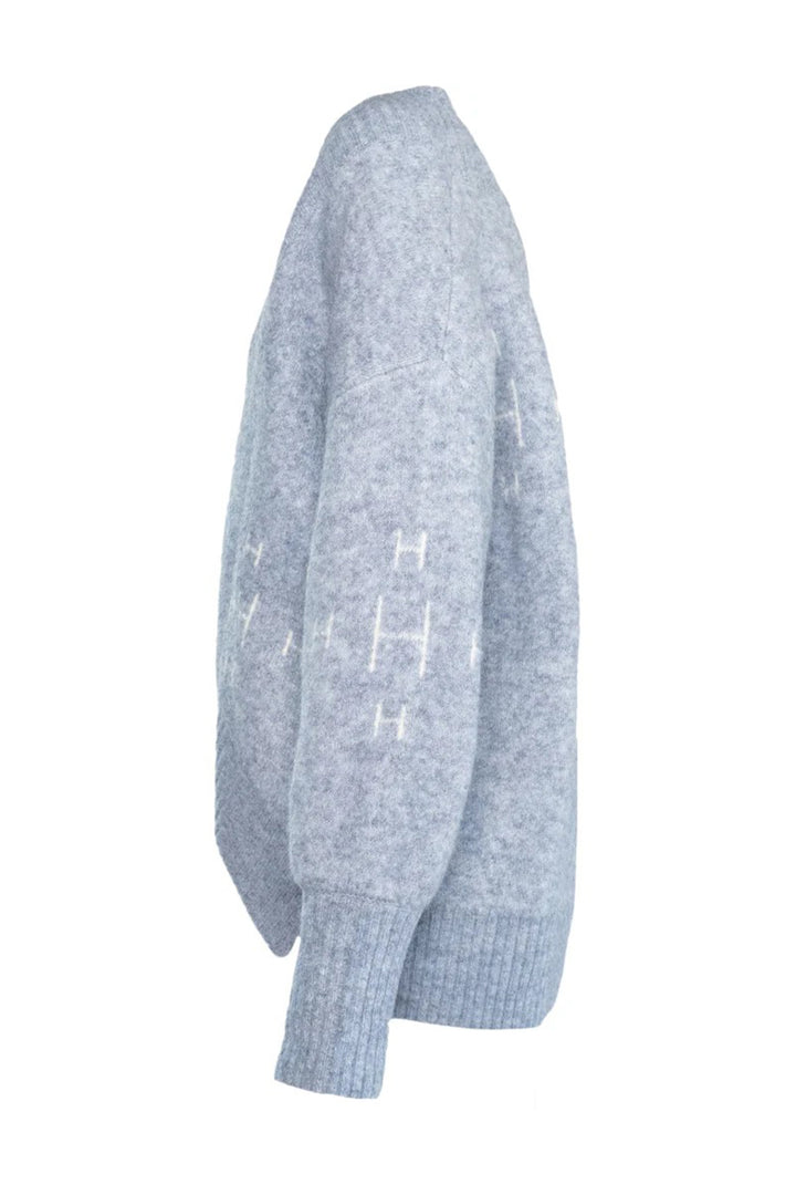 Light blue sweater with white text on a white background