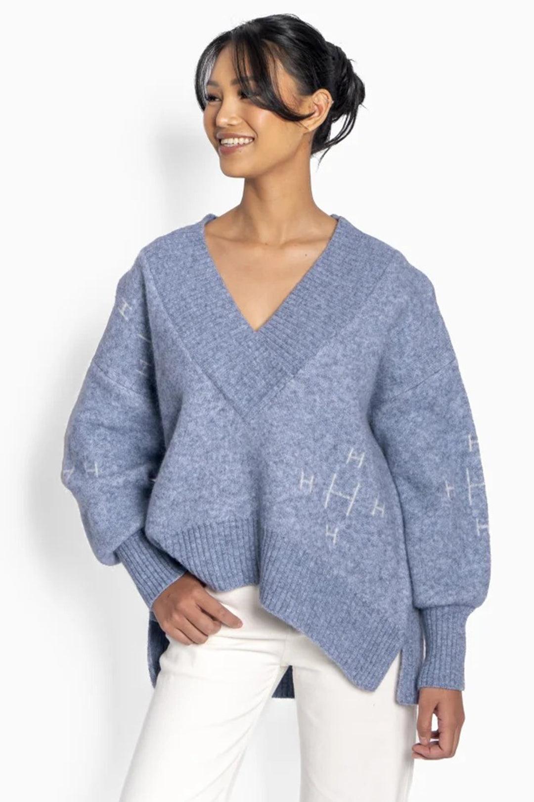 Woman wearing a blue sweater with a white background