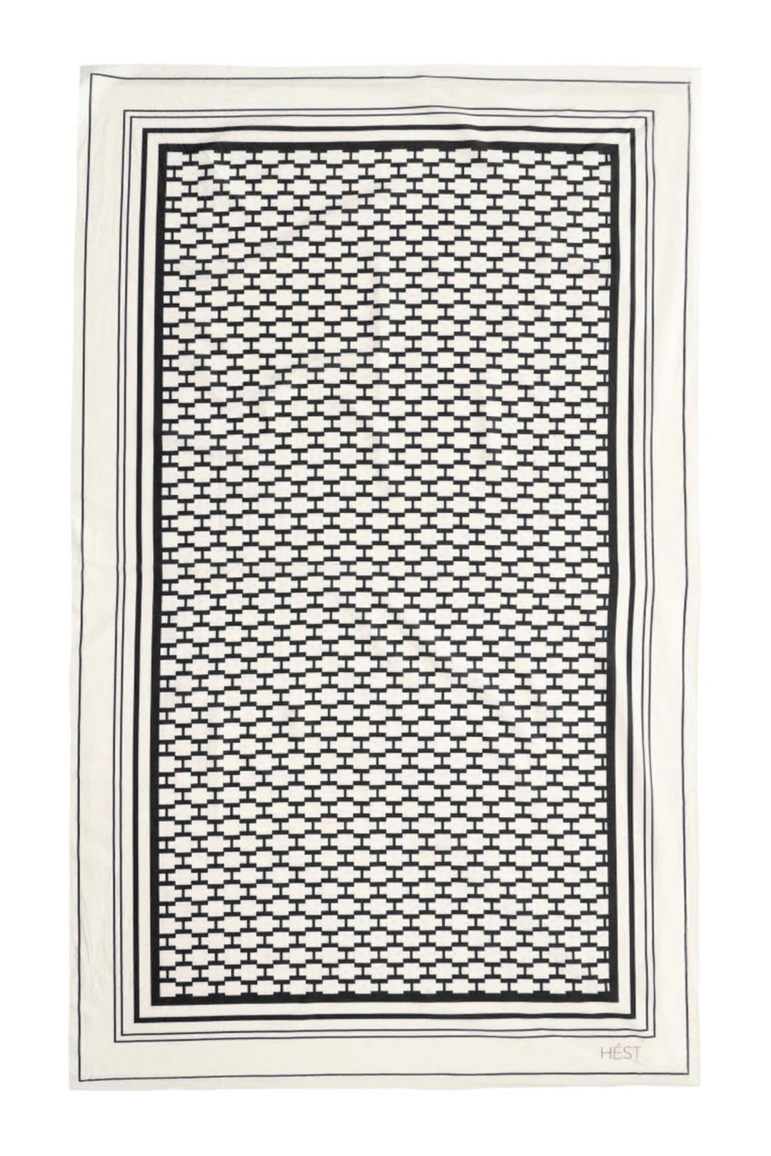 Decorative black and white patterned sarong on a plain background