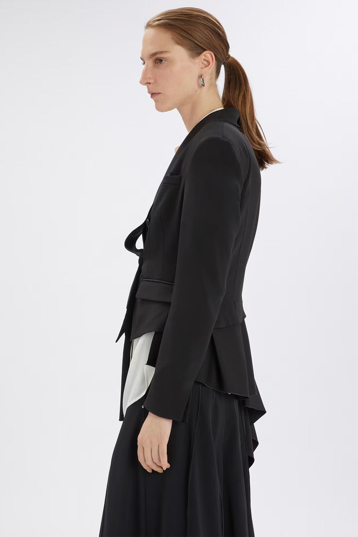 Woman wearing a black layered outfit on a white background