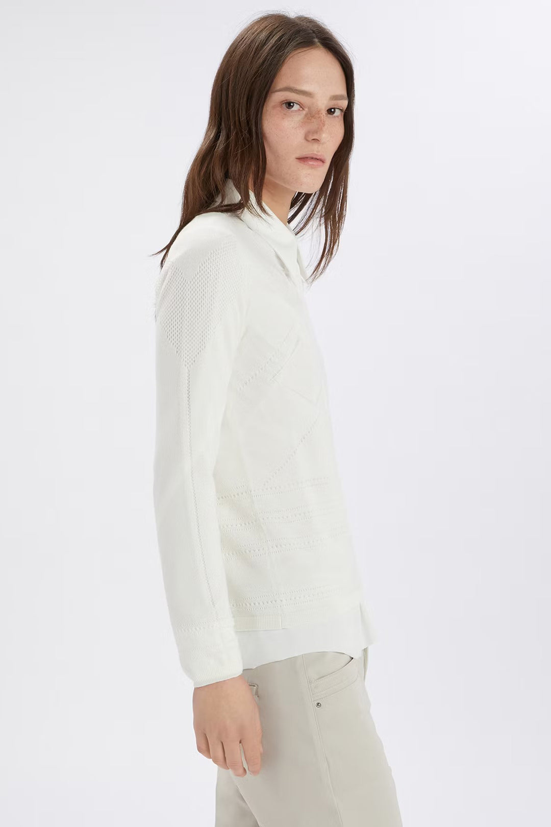 Person wearing a white long-sleeve shirt on a white background