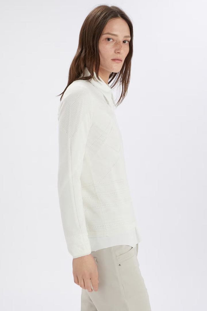 Person wearing a white long-sleeve shirt on a white background