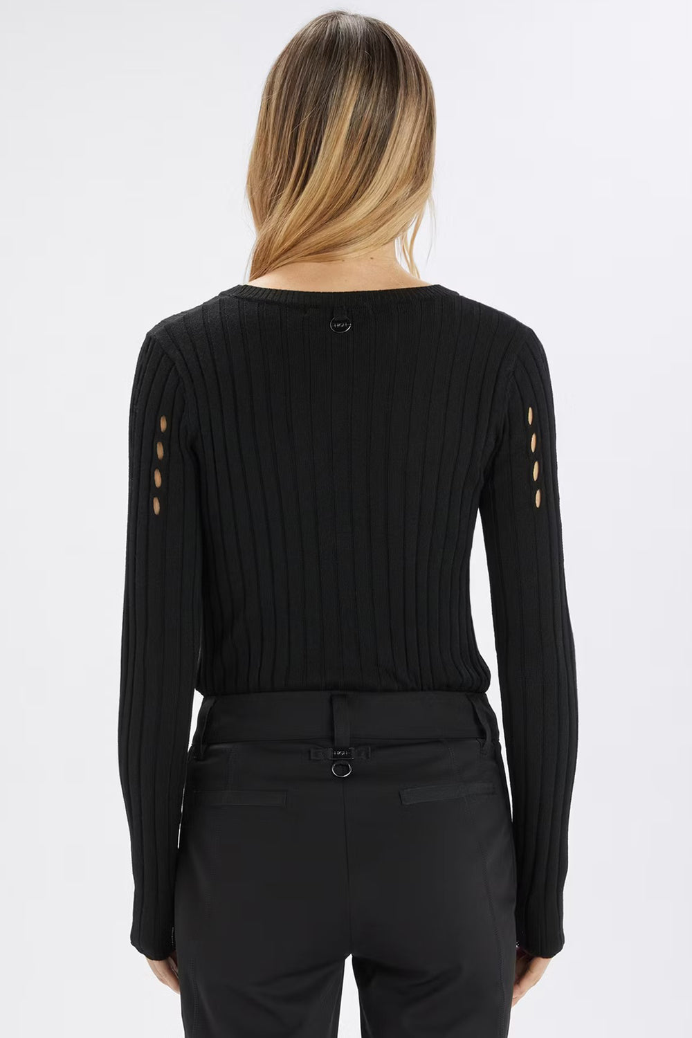 Black long-sleeve top with cut-out details on a white background
