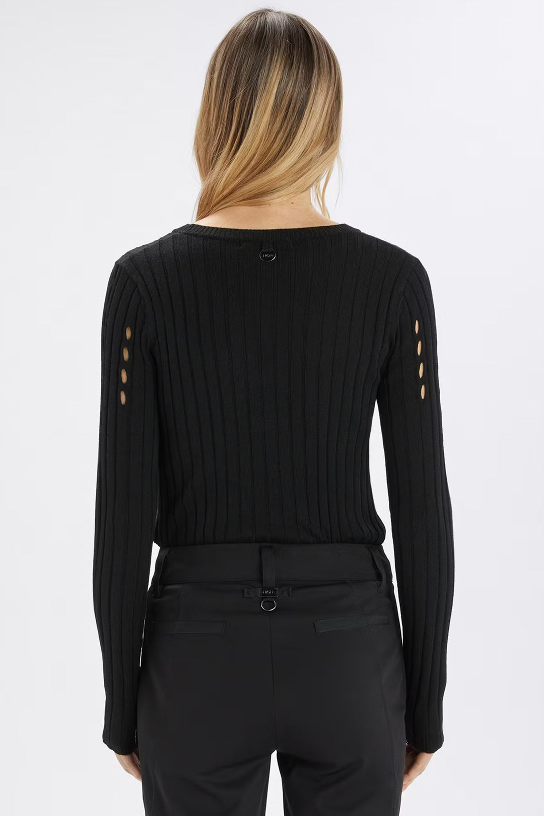 Black long-sleeve top with cut-out details on a white background