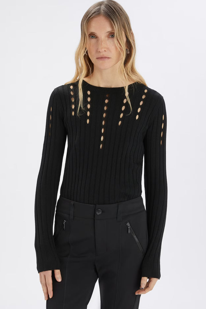 Woman wearing a black long-sleeve top with cut-out details on a white background