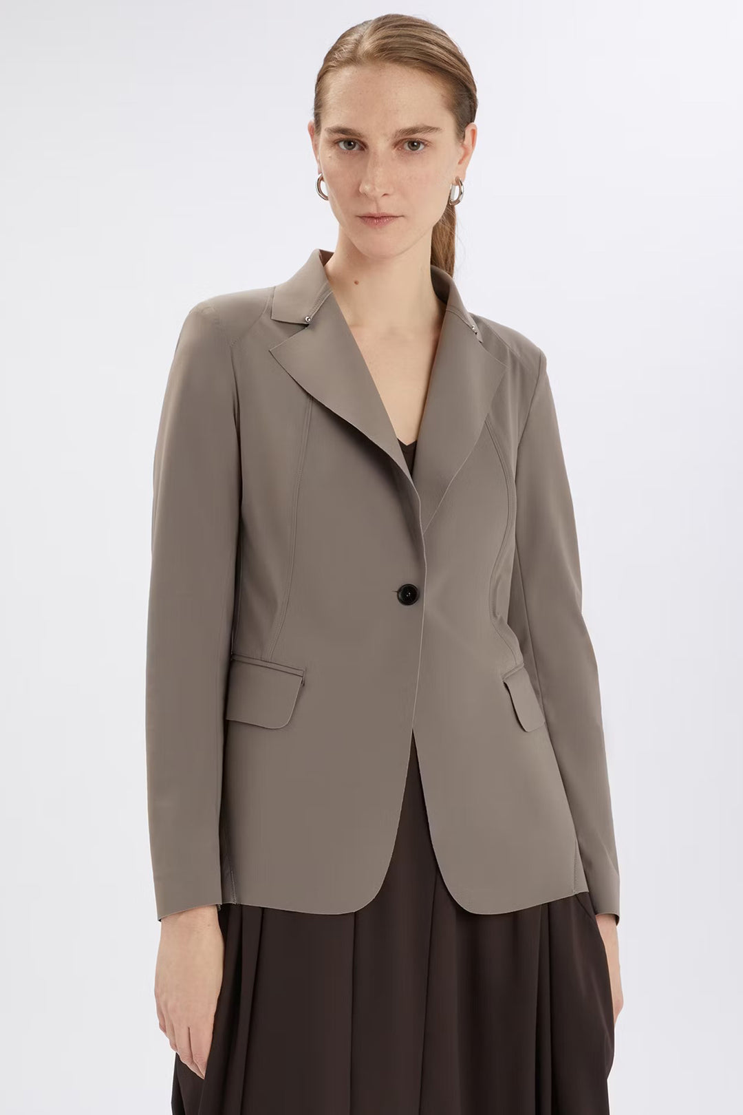 Woman wearing a gray blazer on a white background