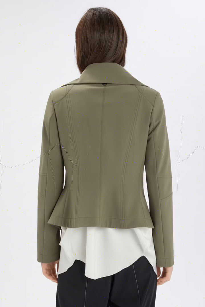 Person wearing a green jacket over a white top on a white background