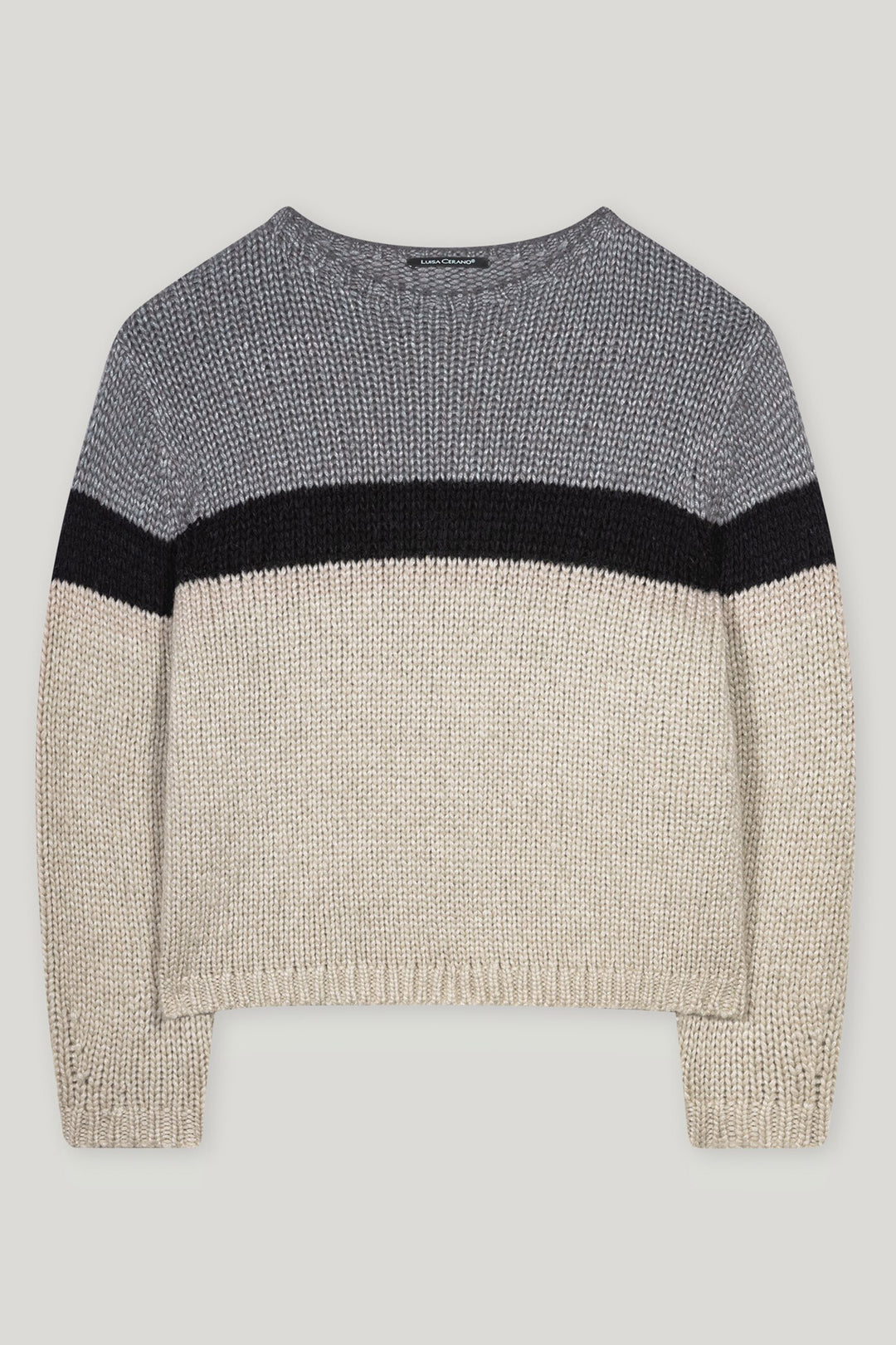 Knitted sweater with color-block design on a light gray background