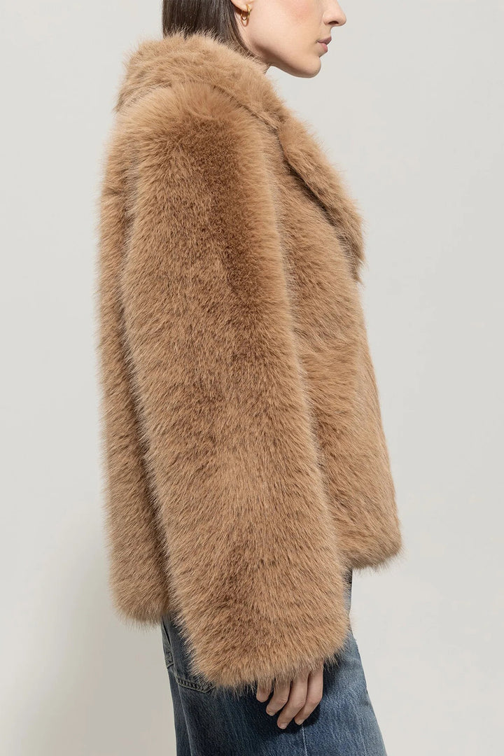 Brown fluffy jacket worn by a person on a plain background
