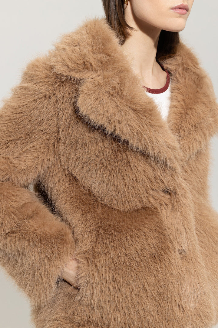 Close-up of a brown fur coat with a neutral background