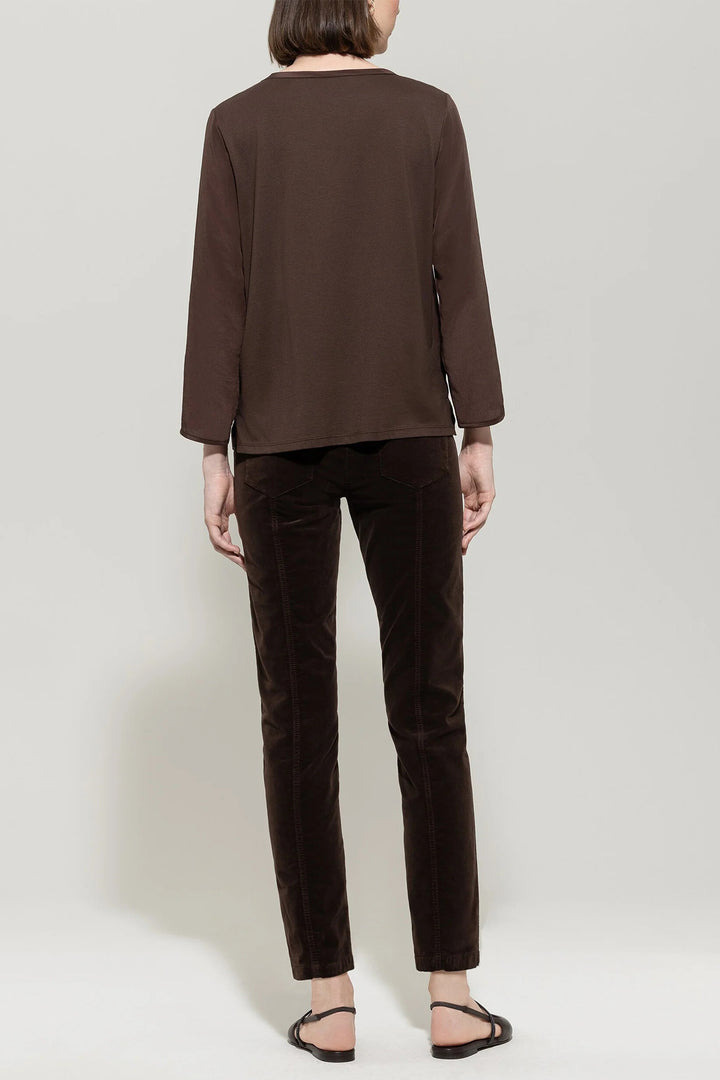 Person wearing a brown outfit on a plain background