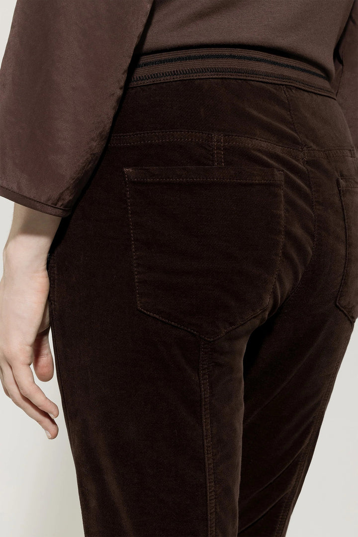 Brown pants worn by a person on a plain background