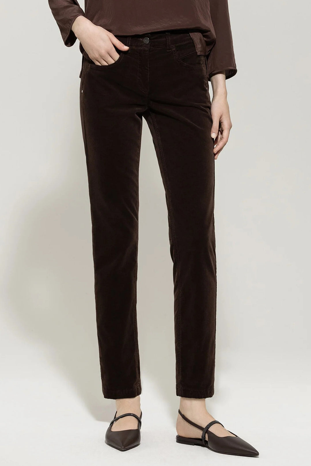 Person wearing brown pants on a white background