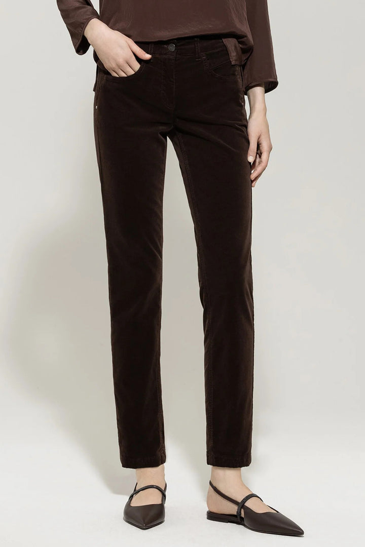 Person wearing brown pants on a white background