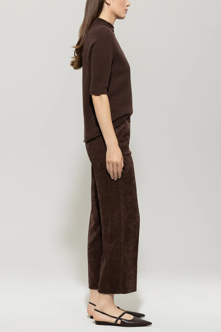 Woman wearing a brown outfit on a white background