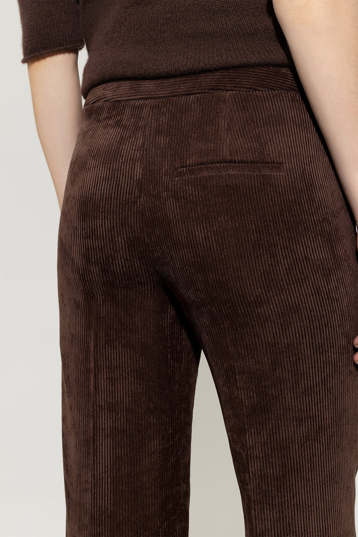 Brown corduroy pants on a plain background