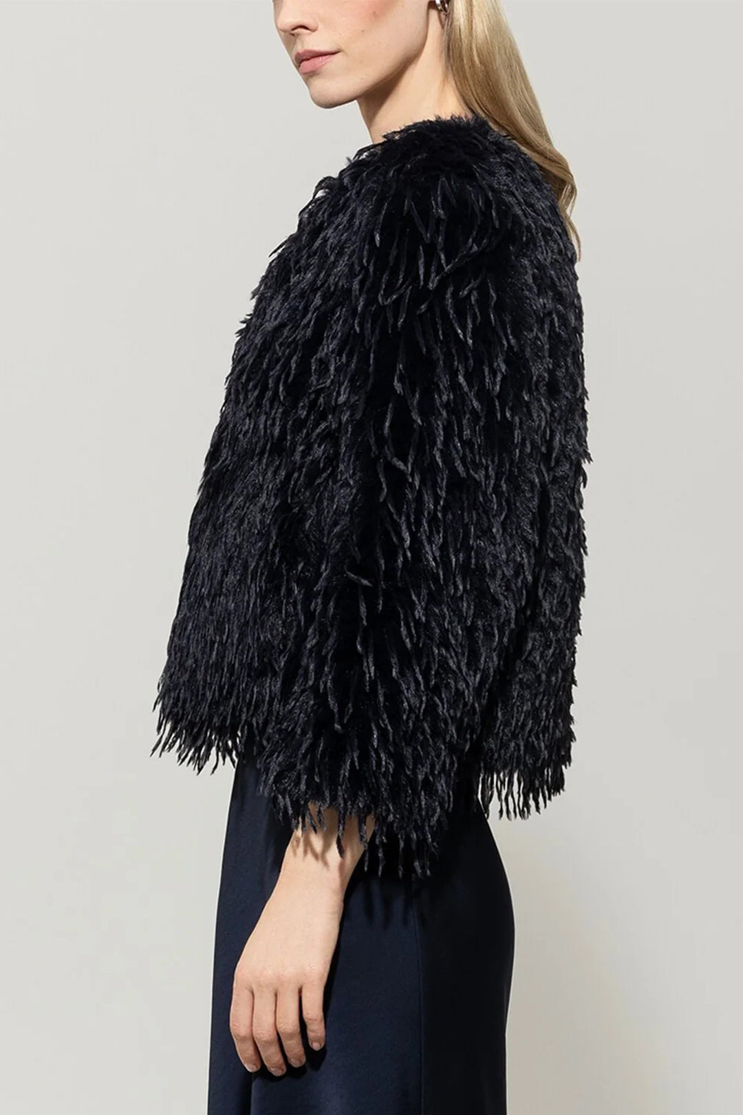 Navy feathered jacket worn by a person on a plain background