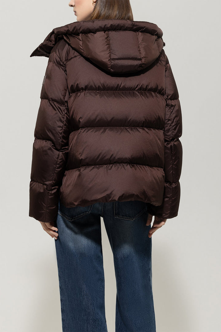 Brown puffer jacket worn by a person on a plain background