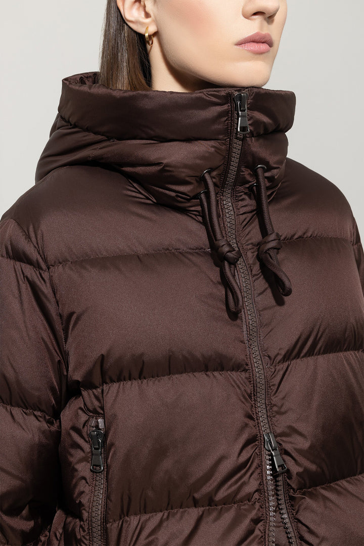Brown puffer jacket worn by a person on a plain background