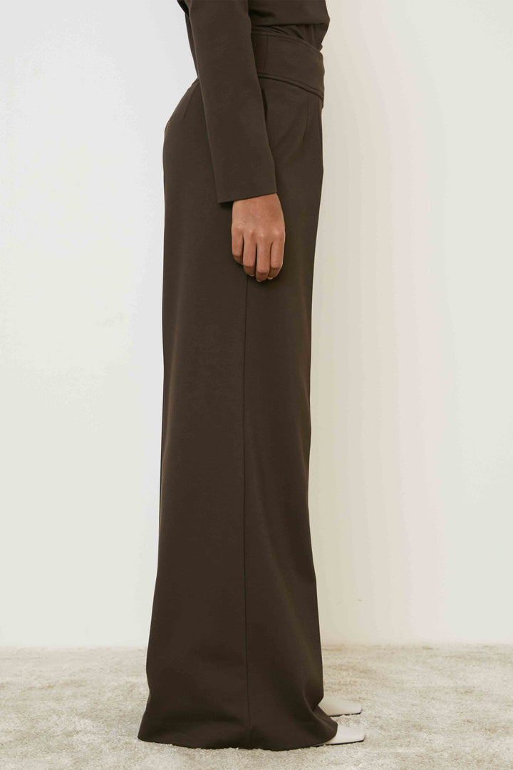 Brown wide-leg pants worn by a person on a light background