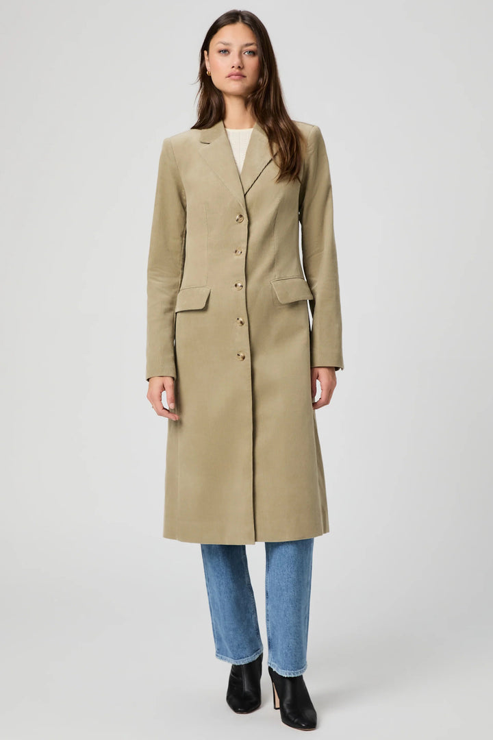 Woman wearing a beige coat on a white background
