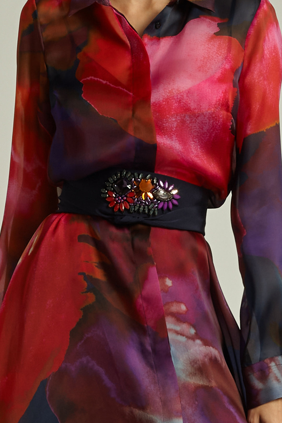 Colorful dress with a decorative belt on a neutral background