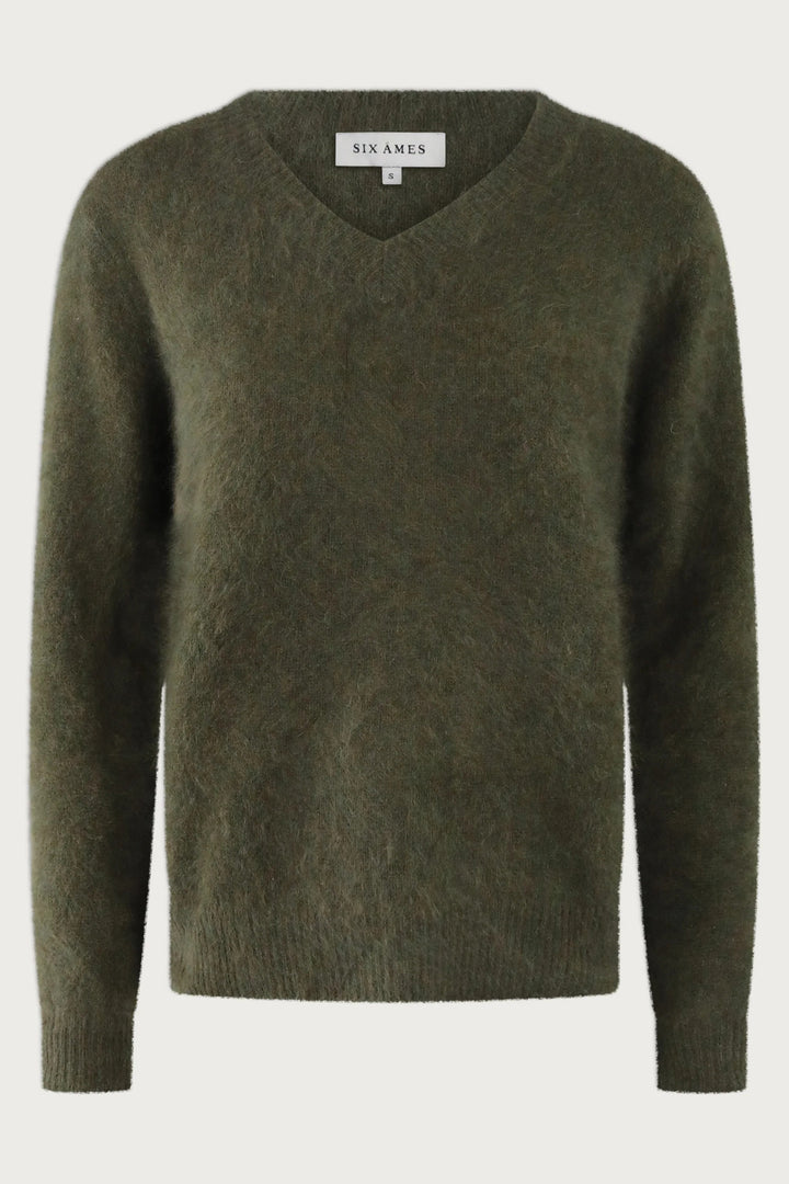 Green sweater with 'Six Ames' label on a white background
