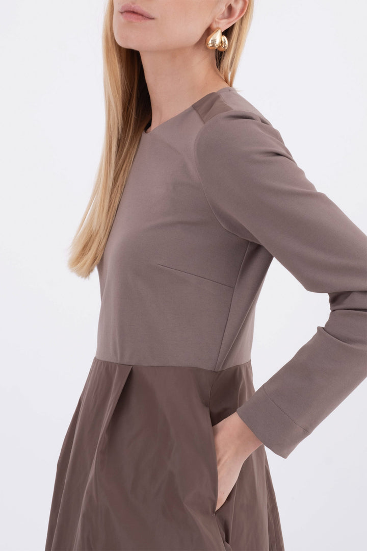 Brown dress worn by a person on a white background