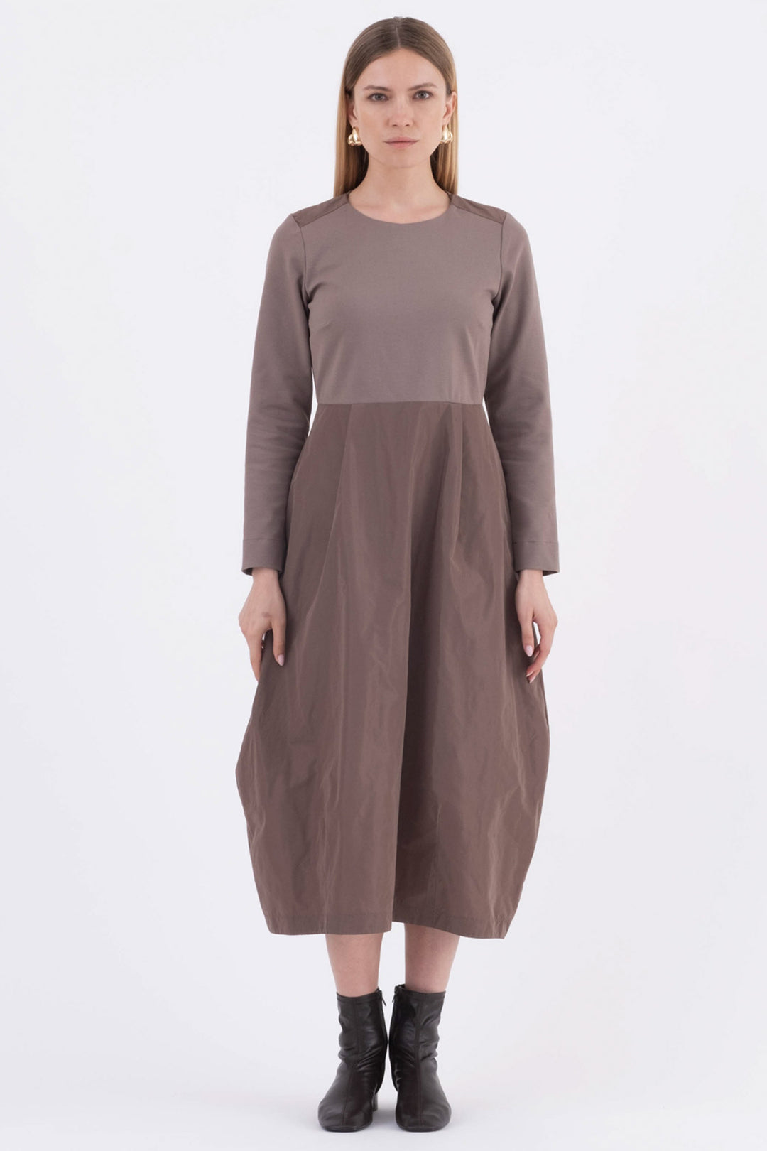 Woman wearing a brown dress on a white background