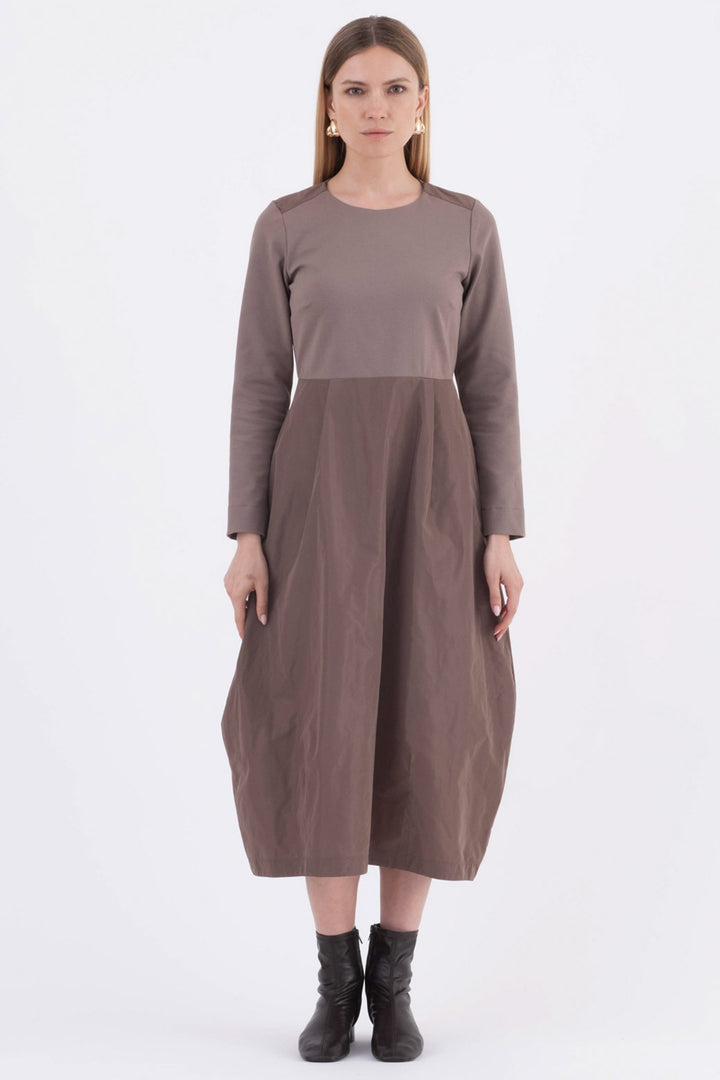 Woman wearing a brown dress on a white background