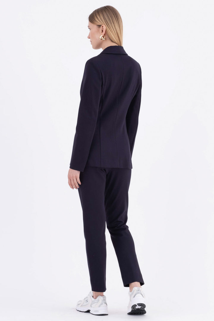 Person wearing a navy suit on a white background