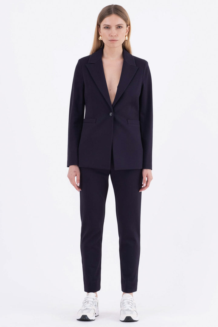 Person wearing a black suit on a white background