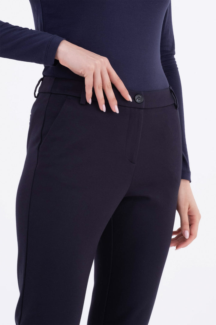 Navy blue equestrian pants worn by a person on a white background